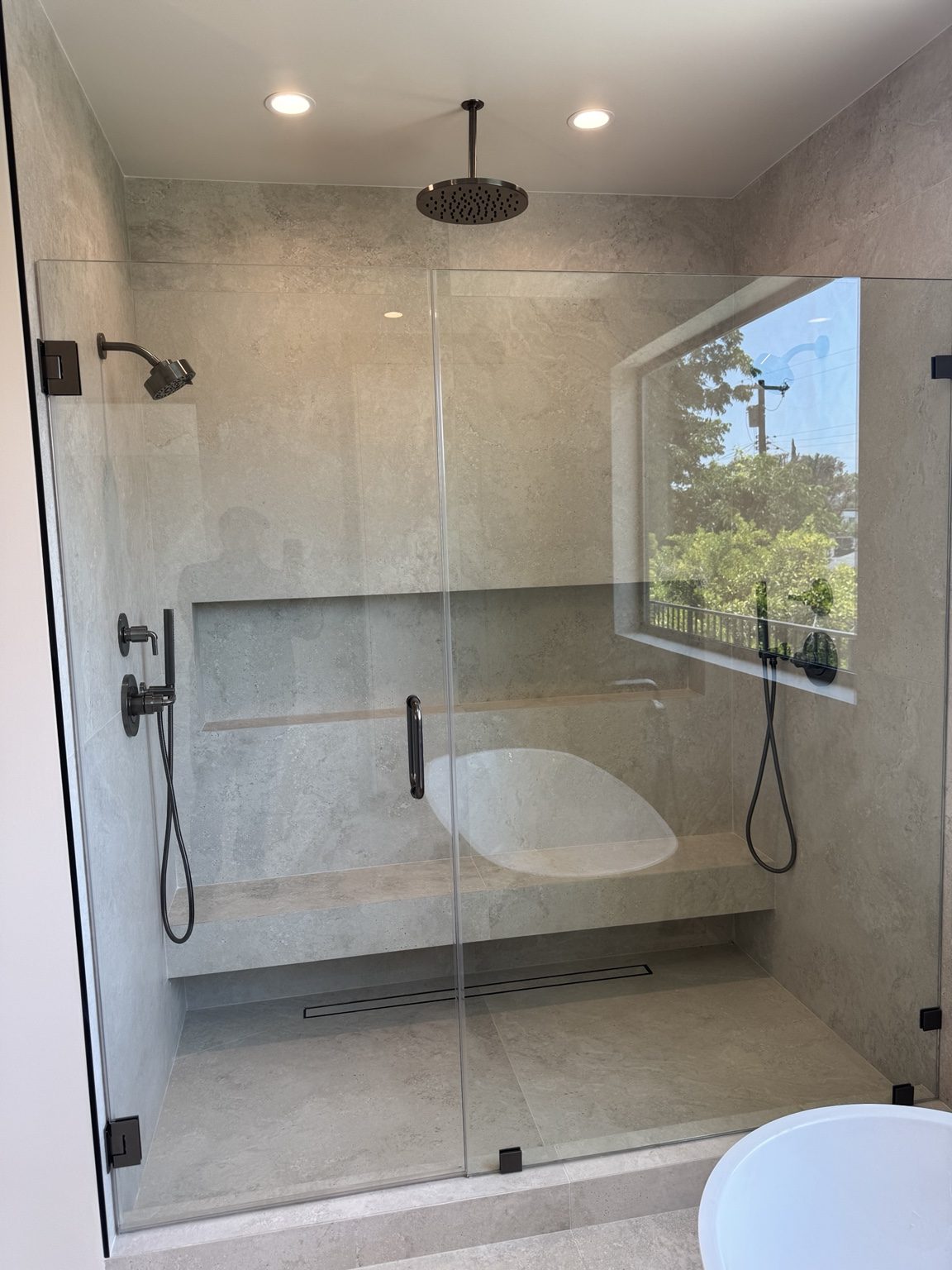 Full-height stone walk-in shower by Coastline DC