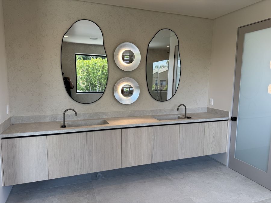 Double vanity with oval mirrors by Coastline DC