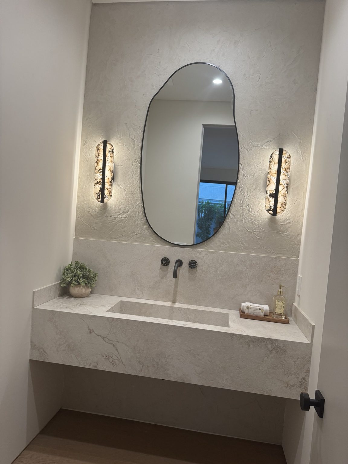 Floating stone vanity powder room by Coastline DC