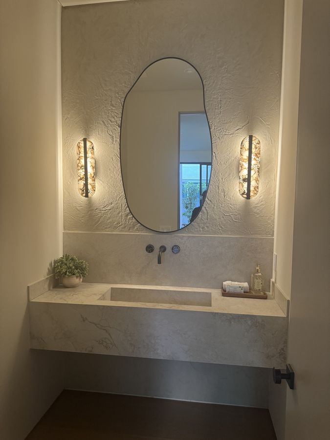Floating vanity with specialty lighting by Coastline DC