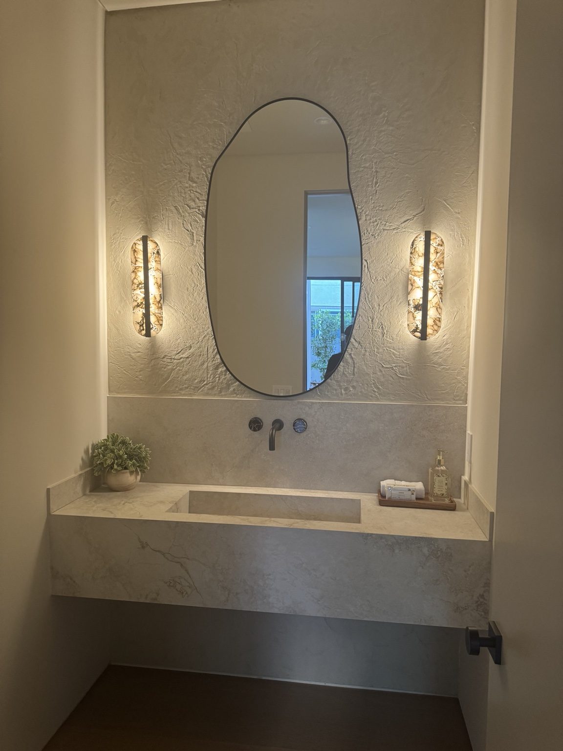 Floating vanity with specialty lighting by Coastline DC