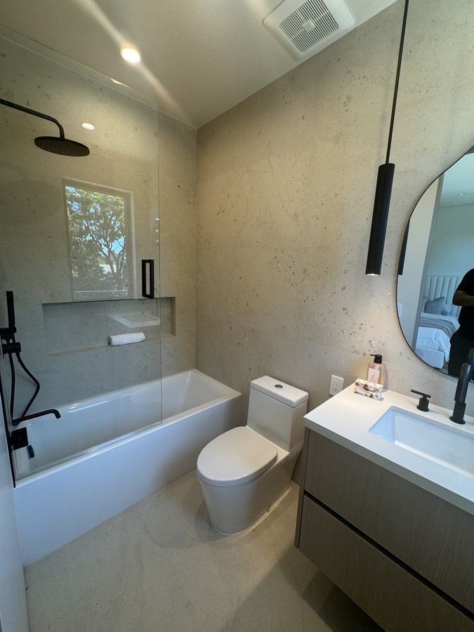 Finished bathroom with tub-shower and vanity by Coastline DC