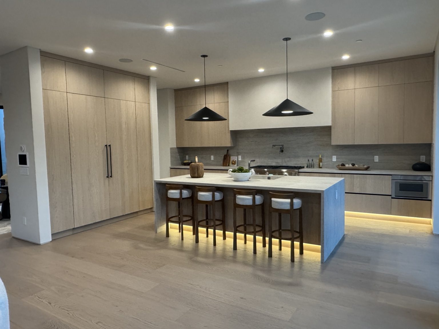 Open-concept kitchen with custom cabinetry by Coastline DC