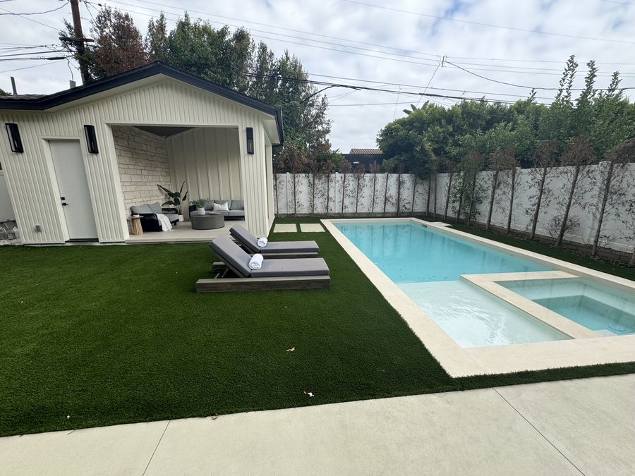 Pool and outdoor living adjacent to a custom home by Coastline DC