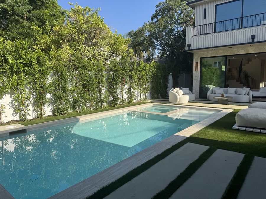 Pool and spa with privacy landscaping by Coastline DC