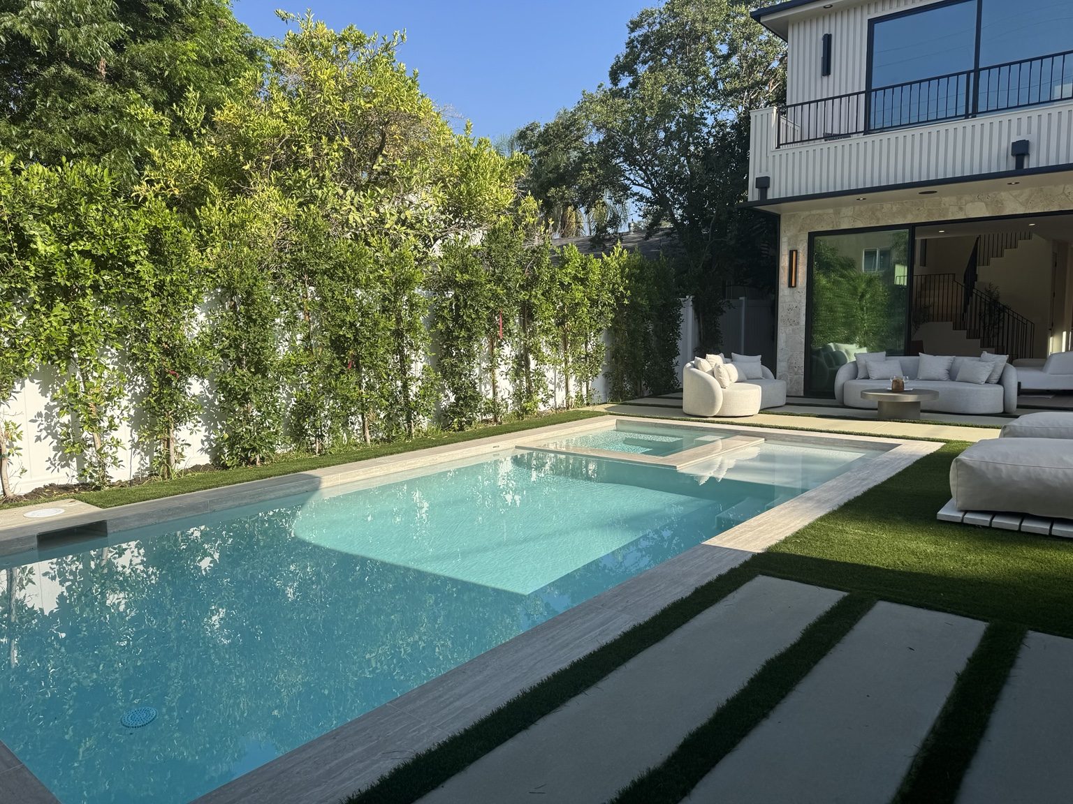 Pool and spa with privacy landscaping by Coastline DC